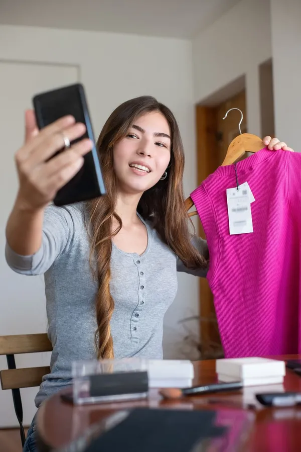 Host presenting a dress on a livestream